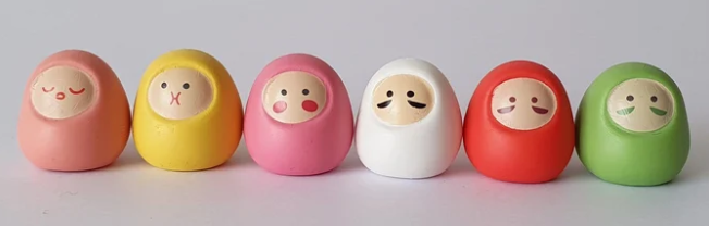small wooden toys with faces on