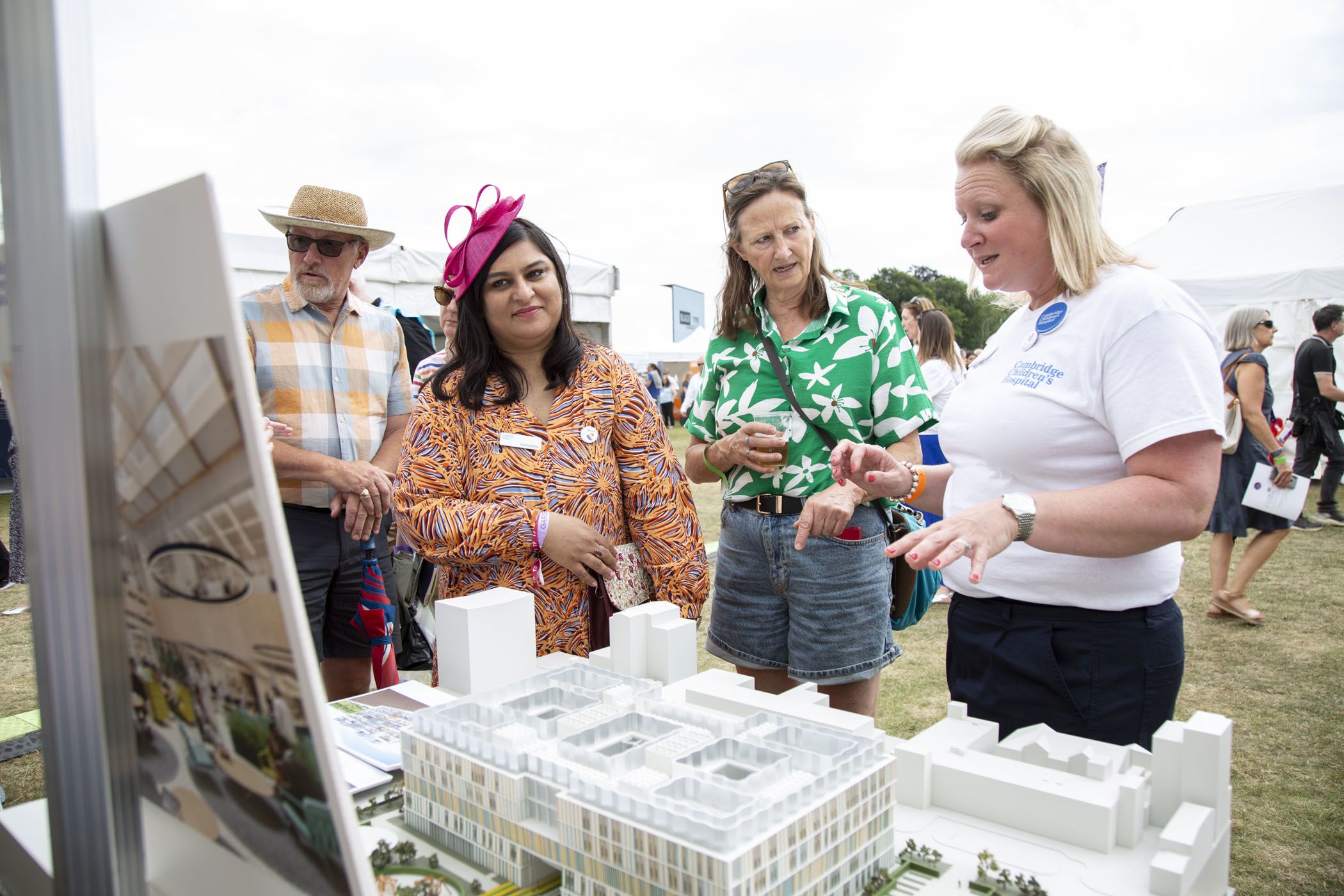 two women talk to a member of the cambridge children's team about the project