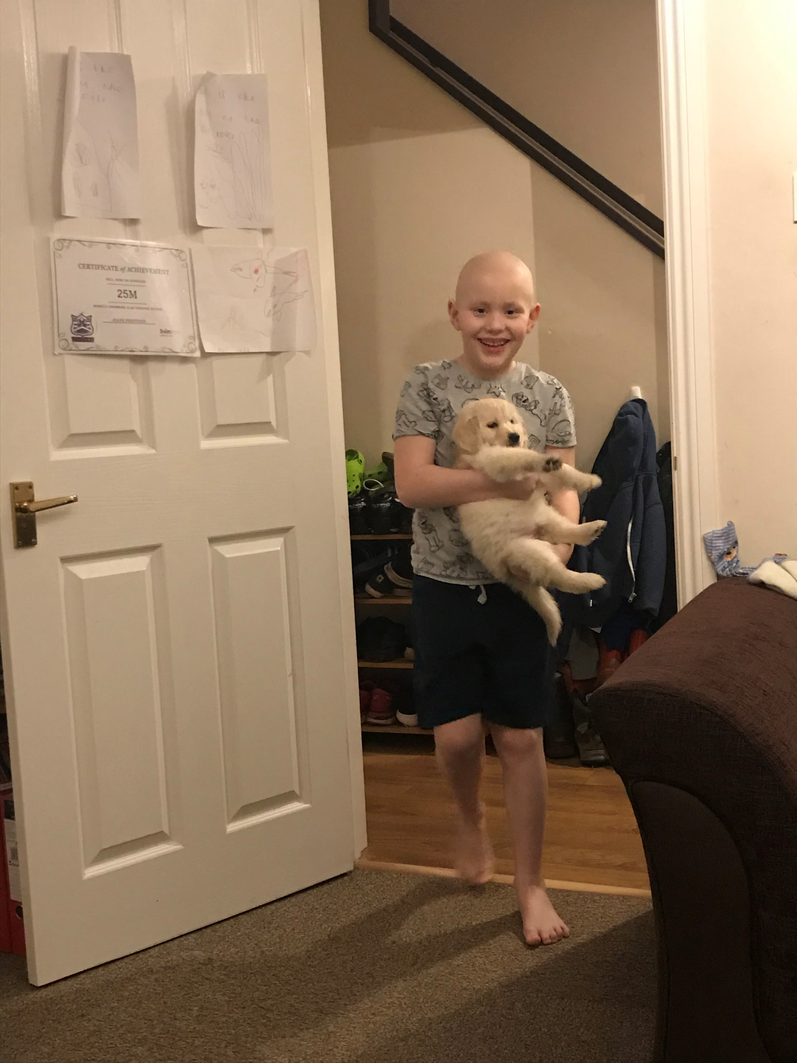 Niall with his new retriever puppy after completing his chemotherapy