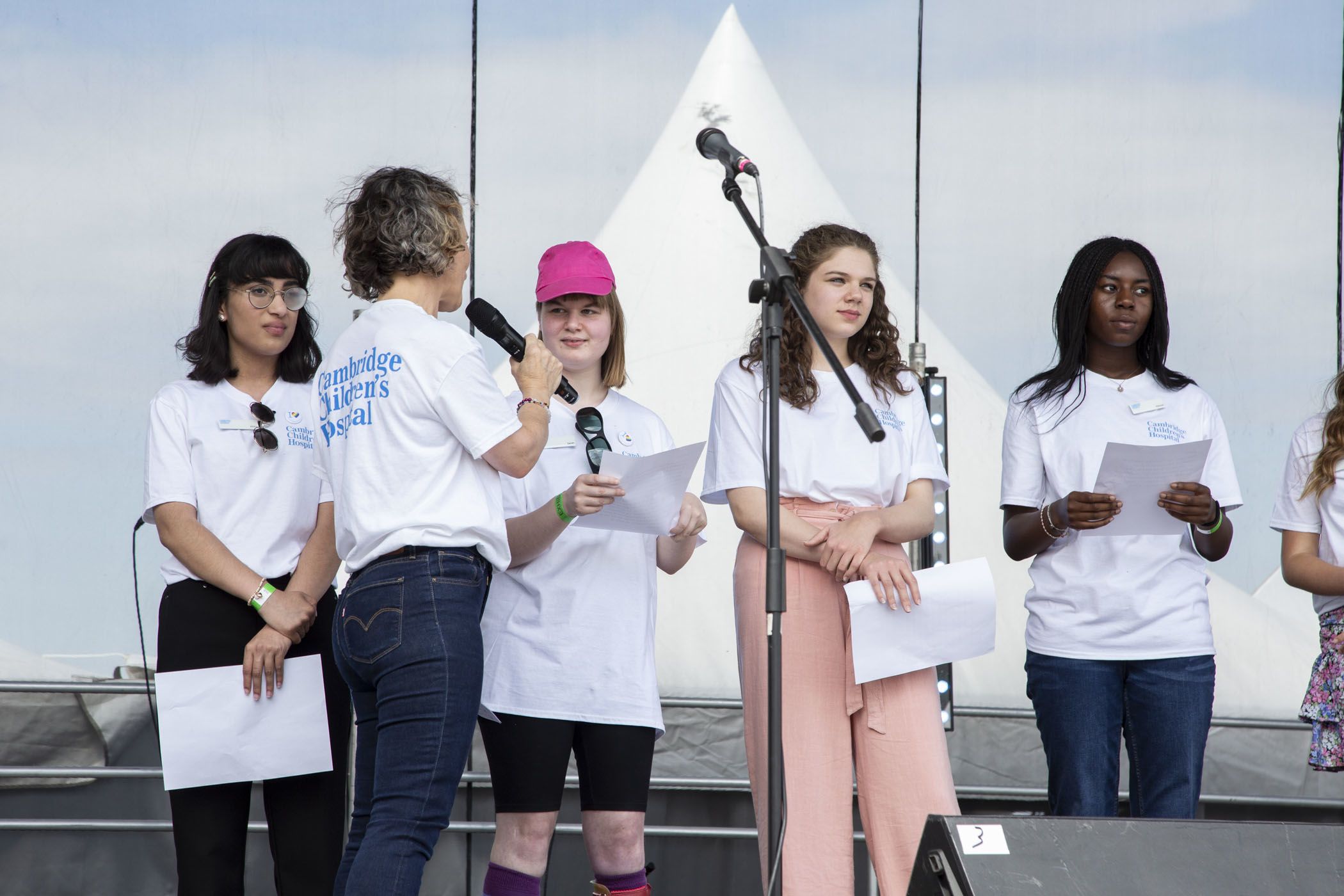 Teenagers prepare to say their speeches on stage at the county day