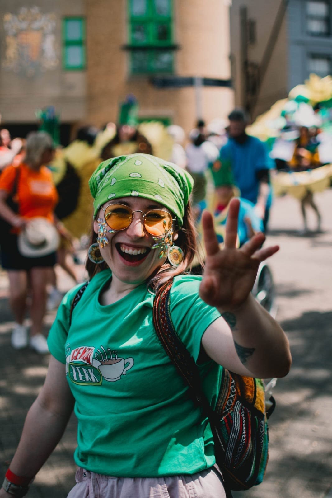 A white woman wearing a purple headscarf and glasses