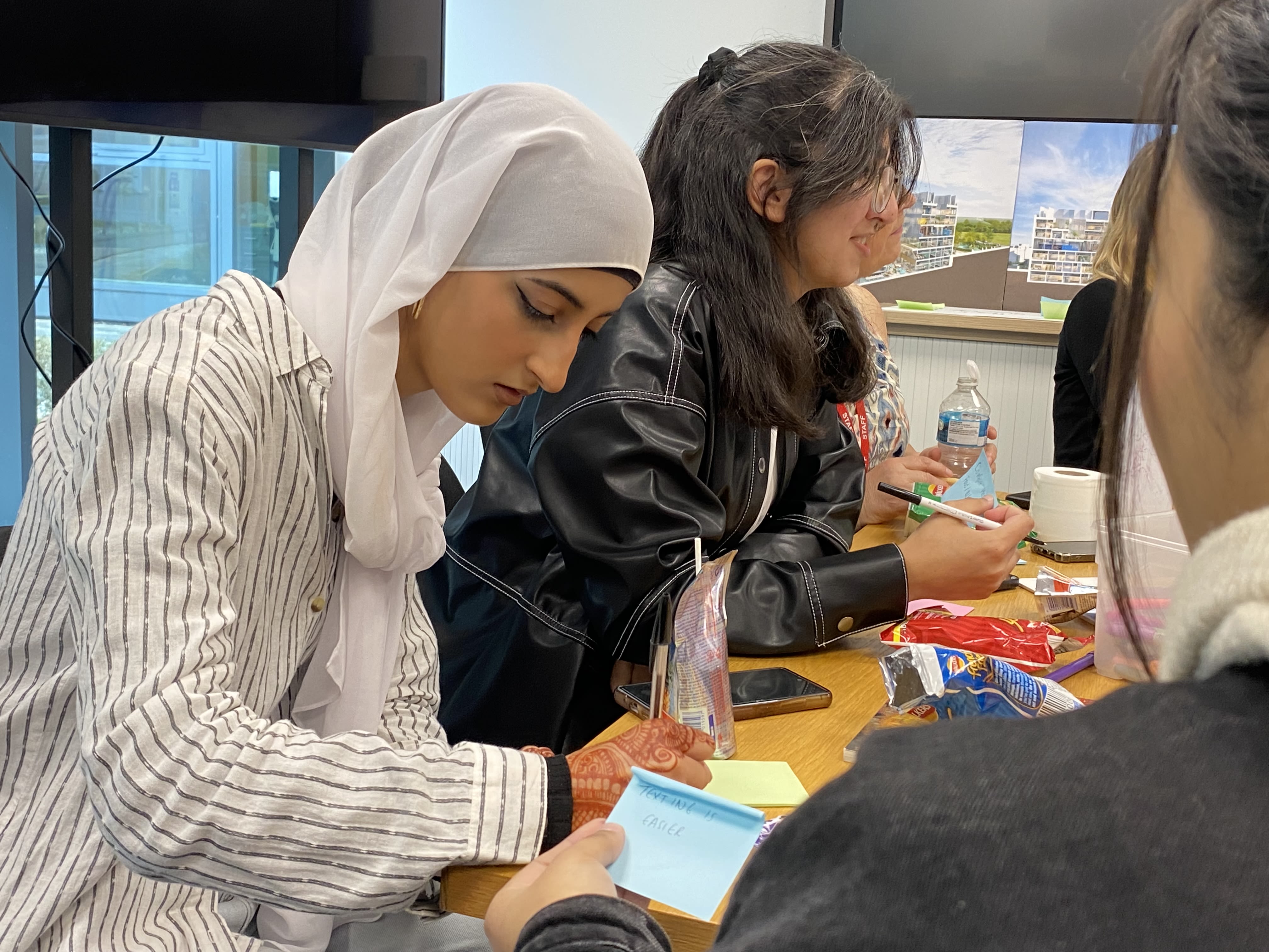 A girl in a headscarf doing colouring