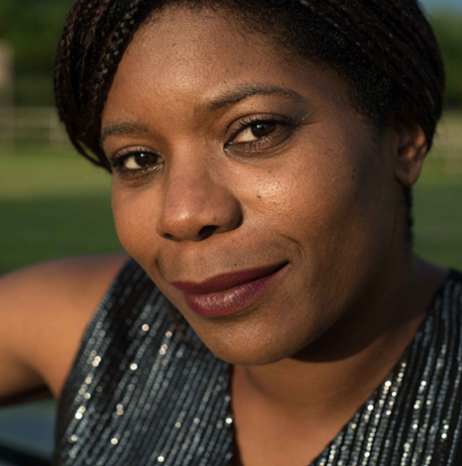 A black woman wearing a sparkly top