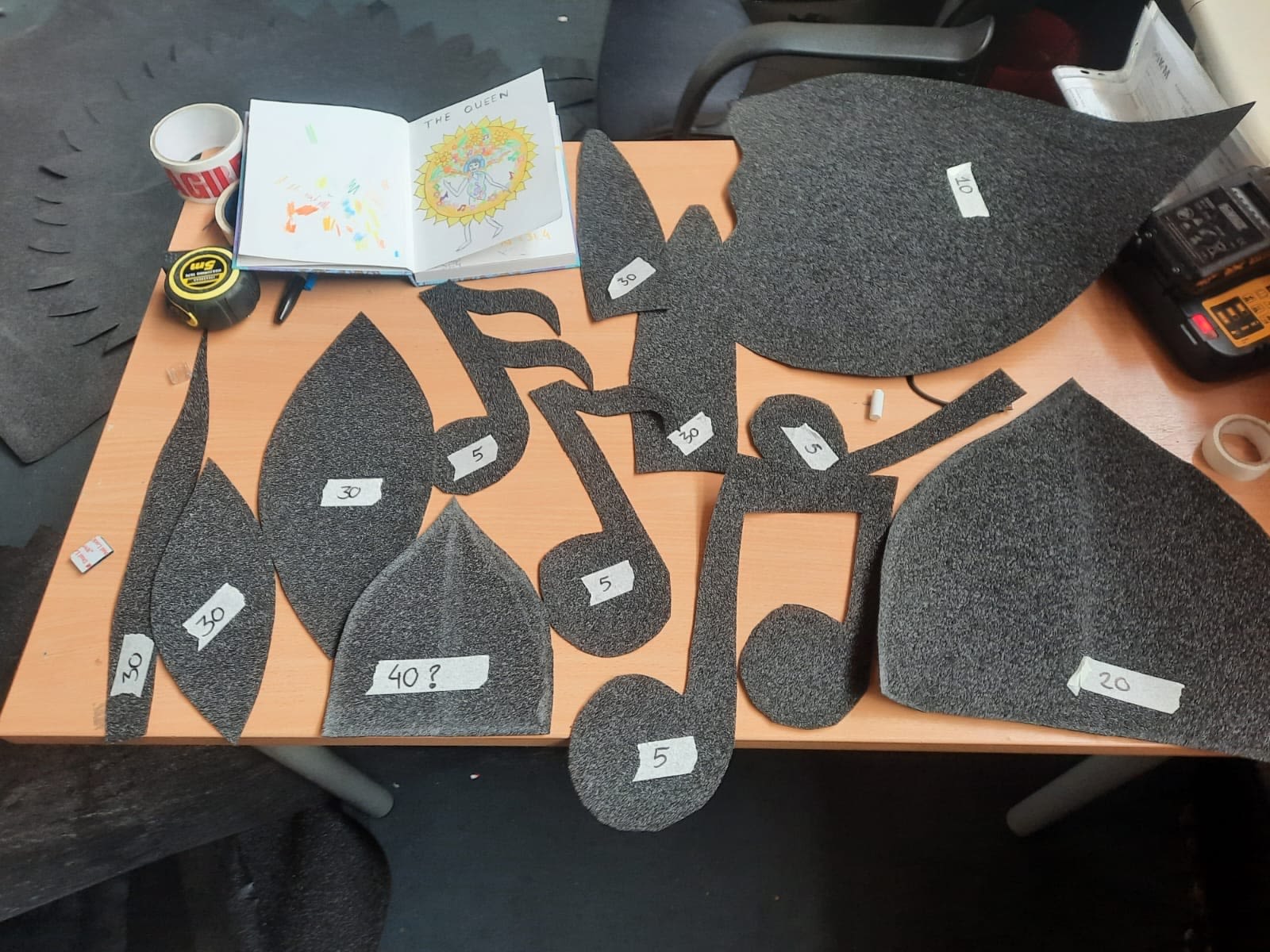 Pieces of grey foam cut out to look like musical notes and leaves